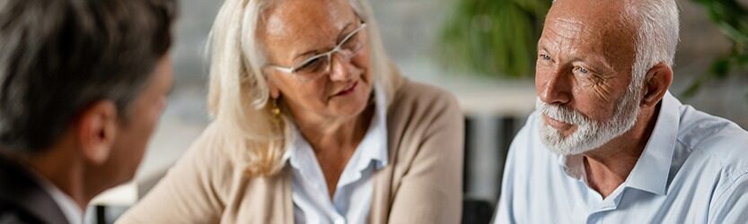 Two elderly individuals in a conversation with a lawyer