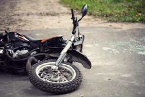 Image of a motorcycle lying on its side on a road