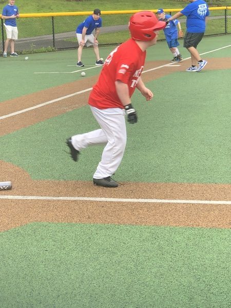 Child in a red t-shirt playing baseball