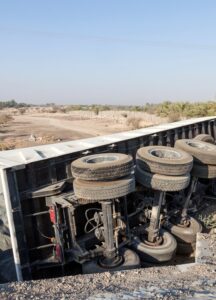 overturned truck on the side of a road